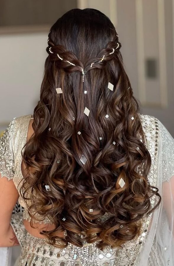 Stylish Jaago night hairstyle featuring soft curls in a half-up design, enhanced with mirror-like diamond embellishments for a festive Punjabi bridal look.