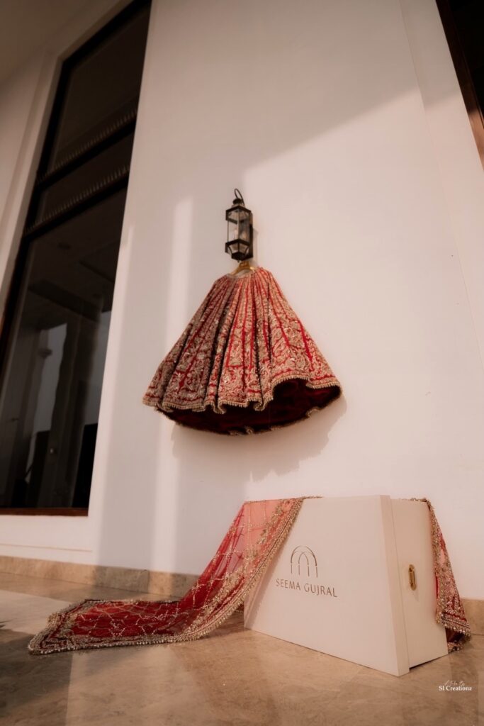 Seema Gujral red bridal lehenga and personalized veil for sunset Punjabi wedding