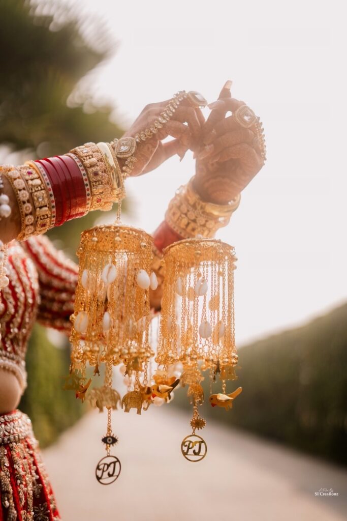 Bride's custom kaleeras with evil eye, elephants, and P&J initials for her sunset Punjabi wedding