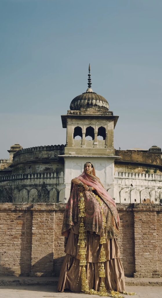 Bride wearing bridal lehenga with kaleere standing in front of Quila Mubarak Patiala shot for kora bridal collection by Akriti Ritika