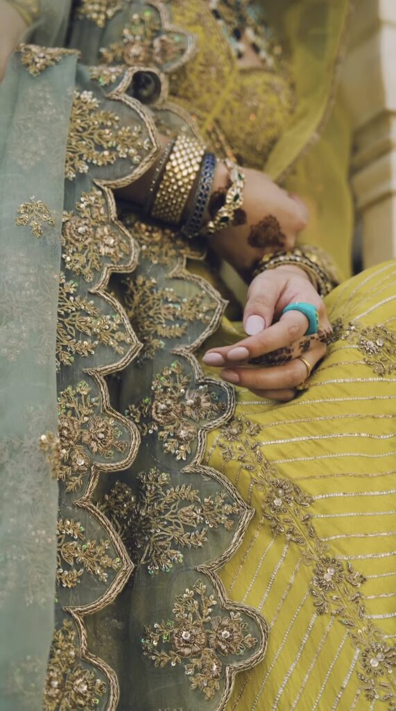Close up of yellow and green bridal outfit with intricate kora embroidery and dupatta detailing
