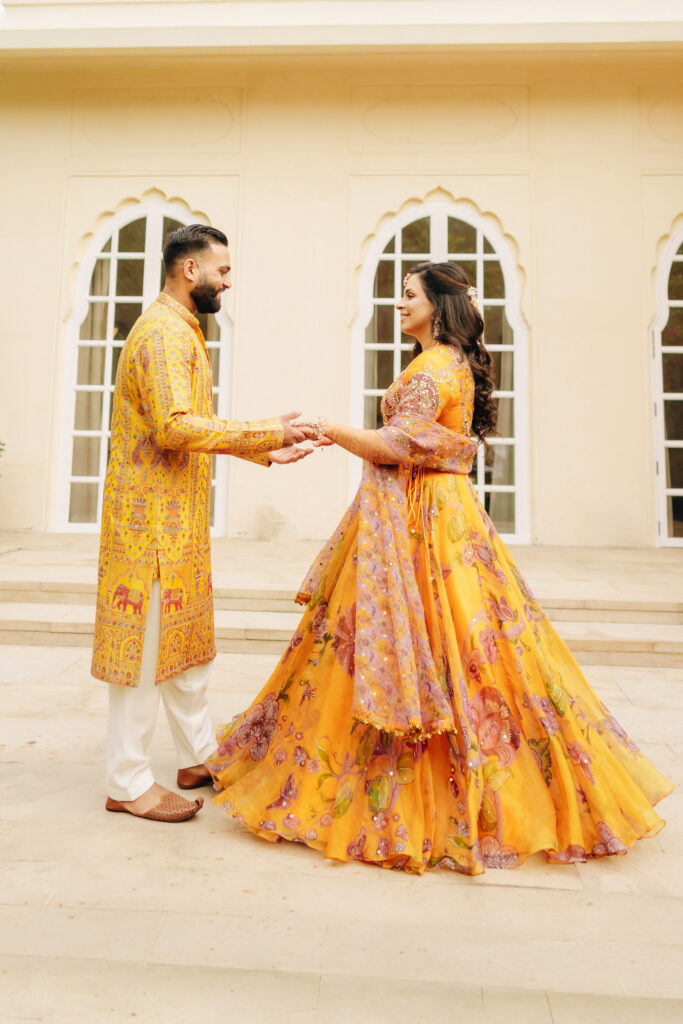 Punjabi bride and groom in haldi outfits by Mahima Mahajan