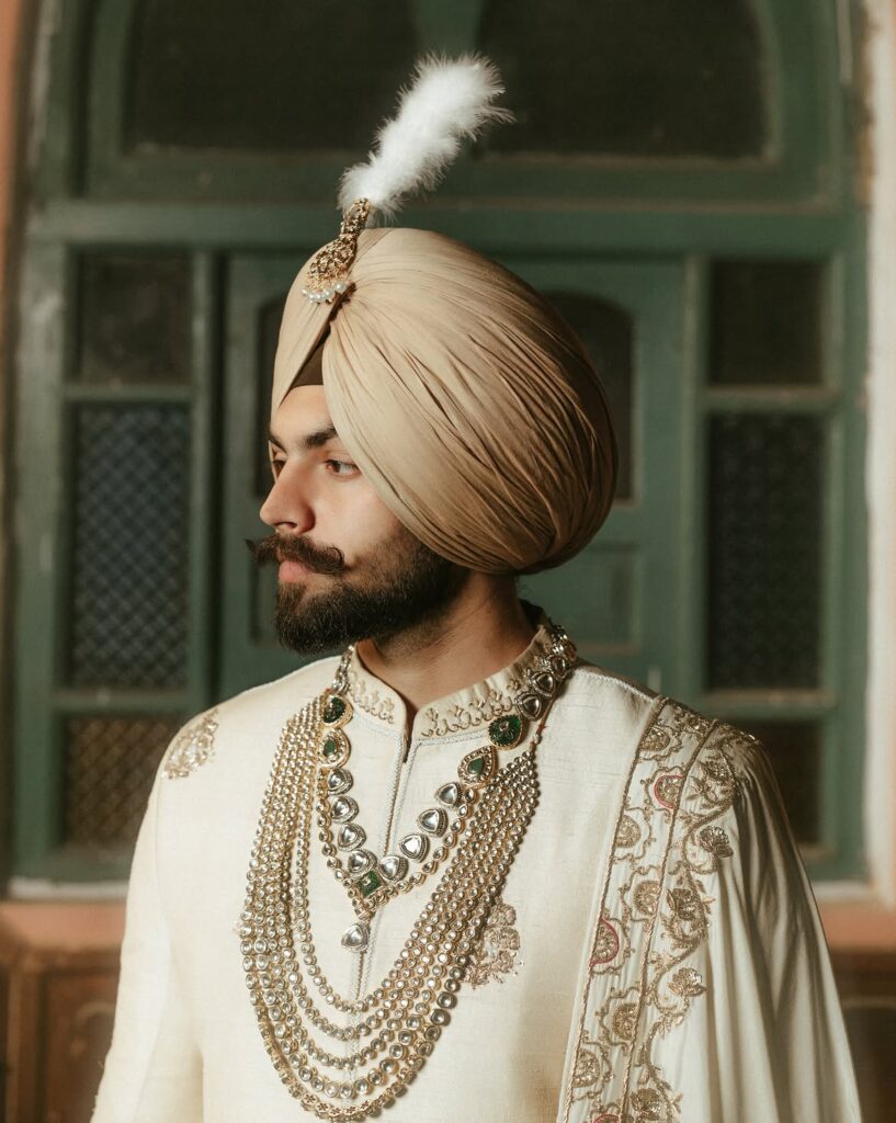 Modern Punjabi groom wearing a traditional safa and wedding sherwani